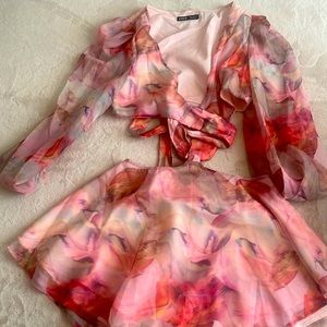 It is a pink dress with slits at the waist.